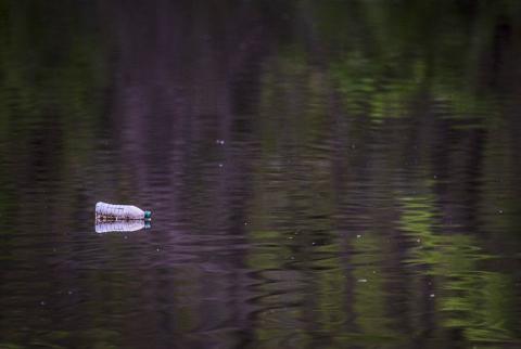 A discarded plastic bottle floats in the Anacostia River in April 2020, near Bladensburg, Maryland.