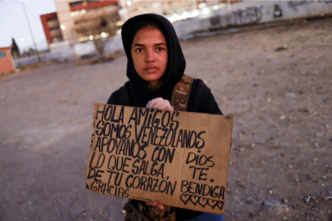 Migrant holding sign