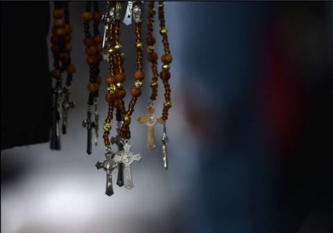 Rosaries are sold by a vendor in Mexico City