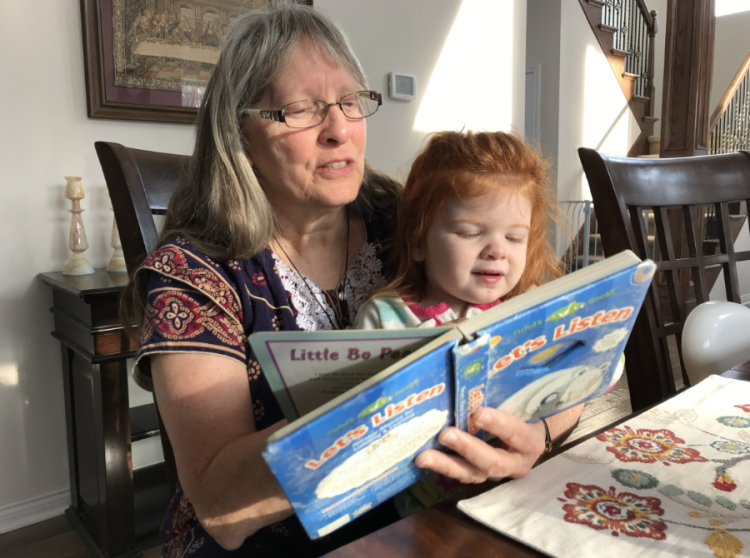 Kathy reading to the baby