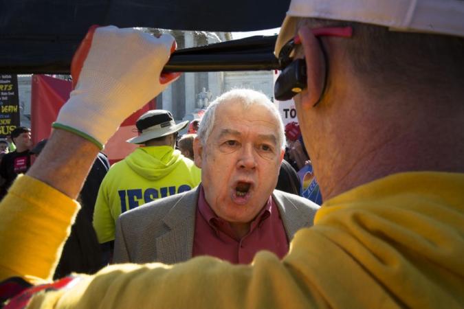 Men argue outside the U.S. Supreme Court in Washington in this April 28, 2015, file photo.