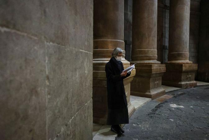 A worshipper wears a face mask to prevent the spread of COVID-19 on Holy Thursday in the Church of the Holy Sepulcher in Jerusalem's Old City April 1.