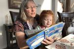 Kathy reading to the baby